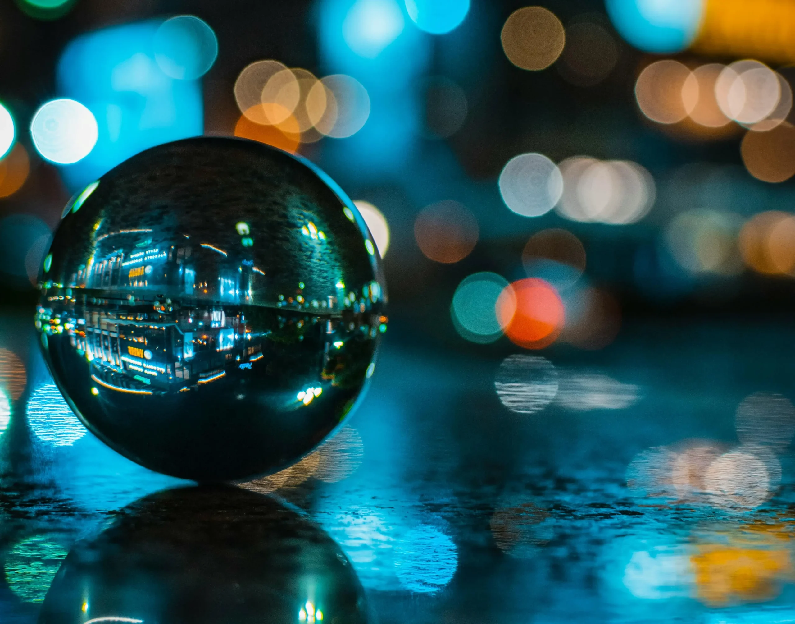 glass ball with reflection of lighted buiding